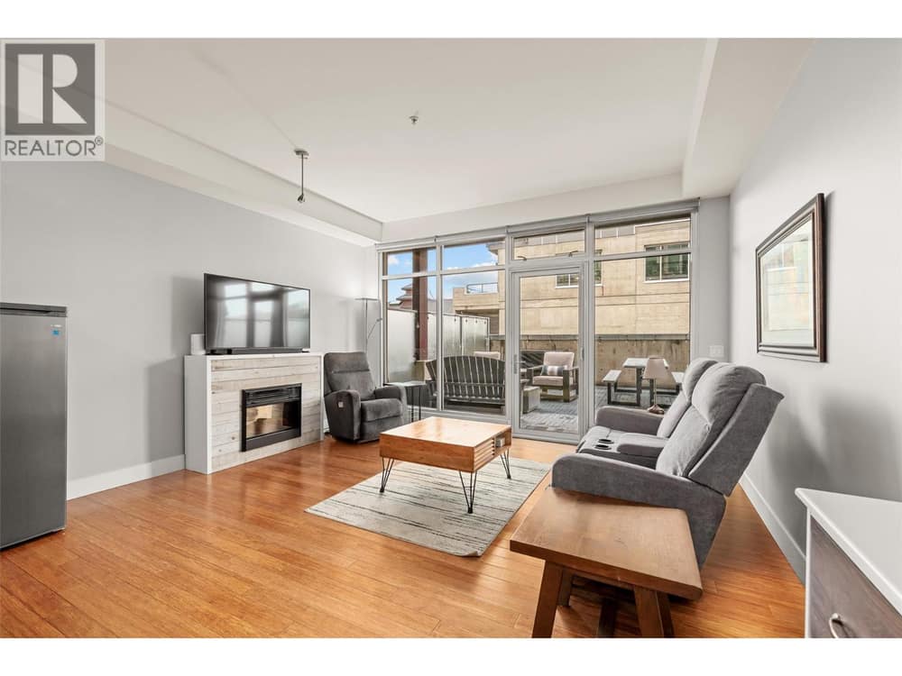 Living Room with electric fireplace and floor-to-ceiling windows for ample natural light