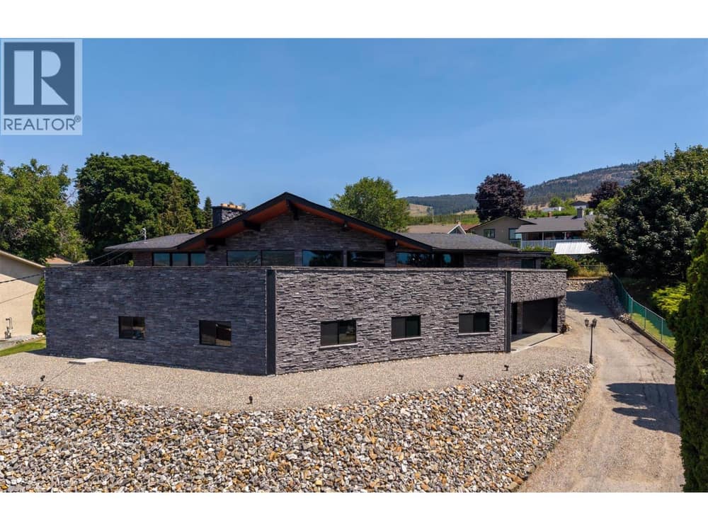 Situated on a quiet street, this unique home boasts city, lake and mountain views