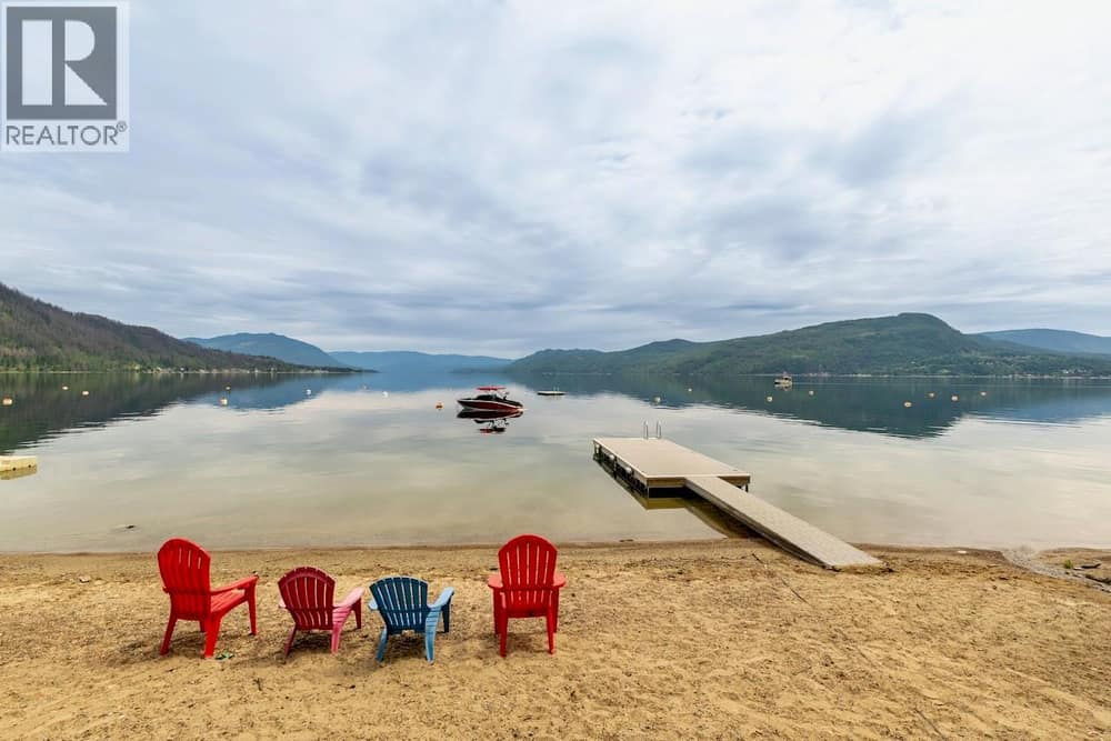 Beautiful lake access and communal beach with shared dock and swim platform.