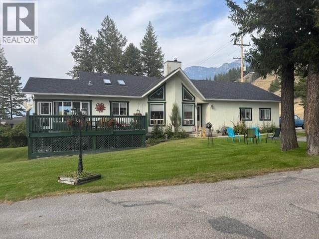 Sunny side of house with deck and attached sunroom