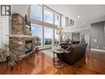 Gorgeous main level living space with open to above ceilings, gas fireplace and