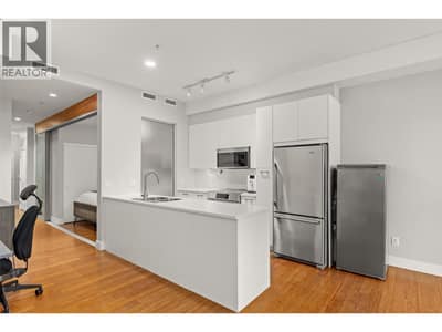 Updated kitchen with newer kitchen appliances, upgraded countertops, an extended kitchen island for added workspace and storage, and a new sink and faucet