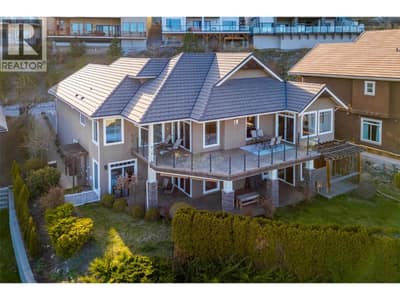 Suited 5 bed/ 4 bath home with panoramic lake views, an attached double car garage, and private backyard space