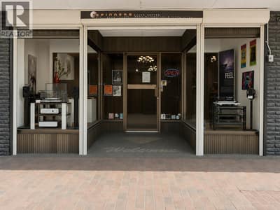 Storefront entrance with display cases and roll down shutters for security
