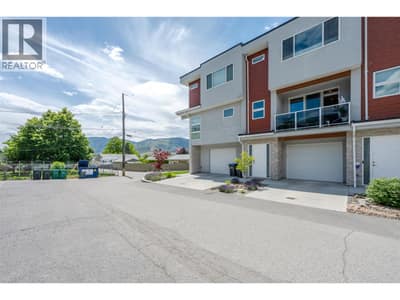 Front of home showing 1 exterior parking spot.