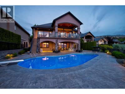 Resort style backyard featuring a saltwater pool, large covered patio and breathtaking lake and mountain views.