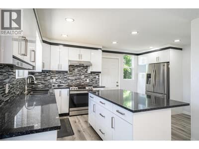 Newly renovated kitchen w/ white cupboards, quartz counter tops - island, pot-lights, new appliances etc.