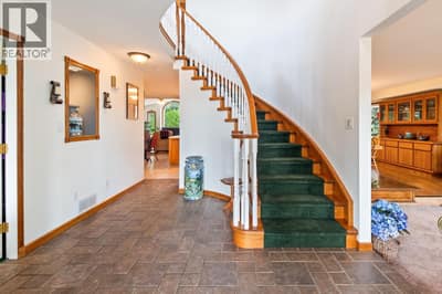 Main Floor: Foyer, upon entering front doors of the home. Features an elegant, curved staircase that immediately creates a striking first impression.