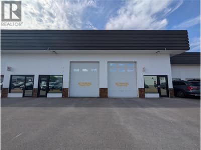Overhead doors at front for Units 108 and 110.