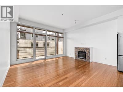 Spacious & bright main living space with new paint, an electric fireplace and floor to ceiling windows!