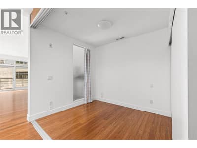 Bedroom #1 | Primary Bedroom enclosed with a sleek folding glass wall system, offering both privacy and light