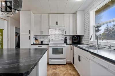 Renovated Kitchen with Island and Subway Tile Backsplash