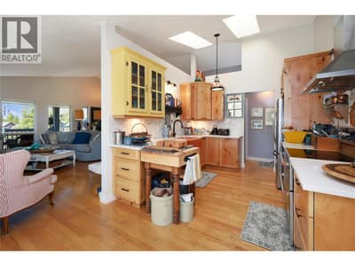 Gently separated kitchen with cottage cabinet features.