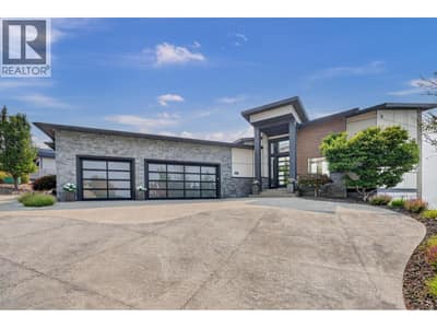 3 Car oversized attached garage with extra detached single-car garage around the left side.