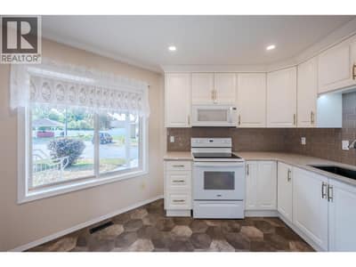 Kitchen with quartz countertops & tile backsplash