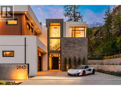 Custom built with award-winning design, this 5-bed/ 4 bath home showcases nearly 4,500 sqft, a gated entrance at the end of a quiet road, and panoramic lake views on a private .9 acre lot