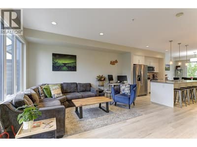 Open concept living space.  The living room is backed to the rear patio access where you have a fenced lawn space.