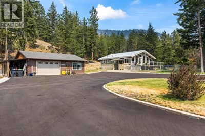 Paved Driveway with Detached Garage and Main Home
