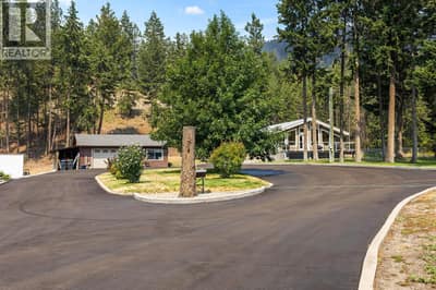 Paved Driveway with Detached Garage and Main Home