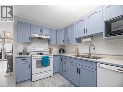 Updated cabinetry, tiled flooring and a practical U-shaped workspace make this kitchen easy to enjoy.