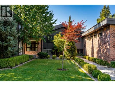 Mature, irrigated landscaping, a spacious front lawn and brick accents create a welcoming first impression on this quiet cul-de-sac