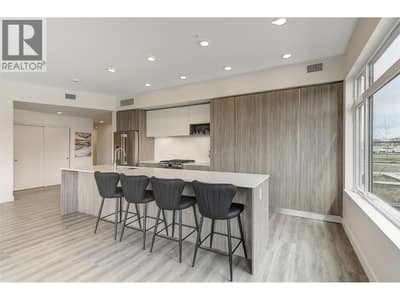 Beautiful kitchen with large quartz island, stainless appliances - gas stove and plenty of cabinet space
