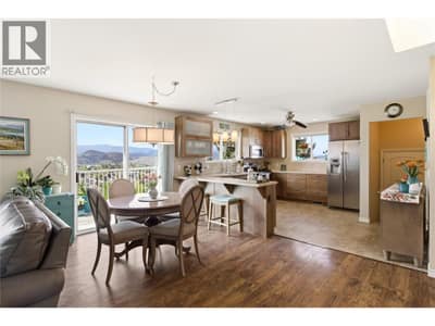 Bright, open-concept kitchen and dining hub featuring high-end finishes, tile backsplashes, and stylish pendant lighting.