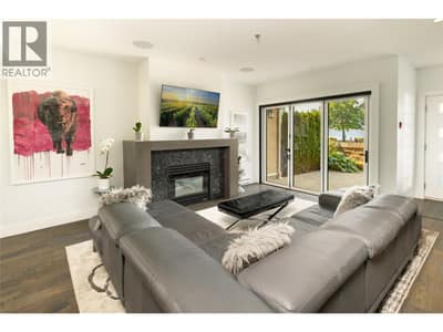 A natural stone gas fireplace grounds the living room