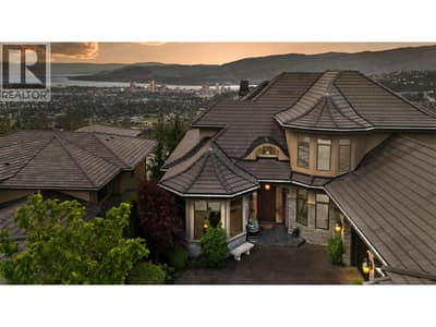 Aerial perspective highlighting the home’s elevated setting and panoramic Okanagan outlook.