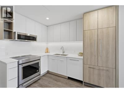 Custom L shaped kitchen with paneled appliances
