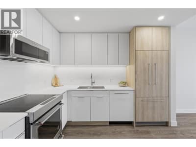 L shaped kitchen with quartz counter, undermount sink