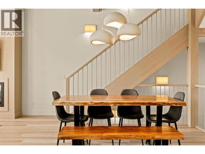 Dining Area l Main Level - With 11ft ceilings & modern feature lighting