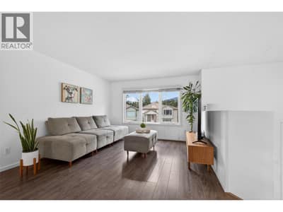 Large windows fill the space with natural light, creating a warm and welcoming feel