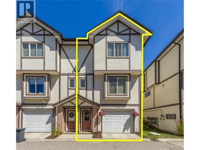 Tandem garage and entry door. Dining room window on main floor and primary suite window on upper floor.