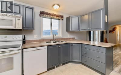 Open concept living, dining and kitchen, with lake and mountain views