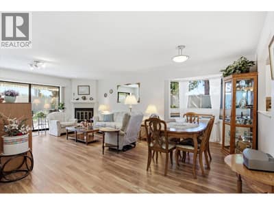 Open concept living room and dining room with sliding doors to private patio