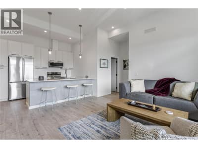 Enjoy the open-concept living room and kitchen with loads of natural light