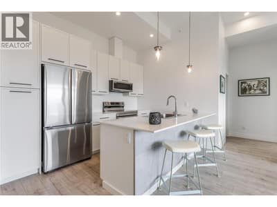Modern kitchen featuring quartz countertops and stainless steel appliances