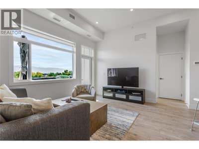Living room with access to the patio. Unit also has in-suite laundry.