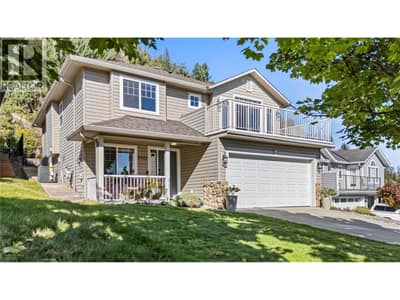Double attached garage with full driveway, mature landscaping and beautiful forest/mountain and lake views.