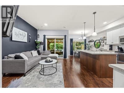 Open concept main floor kitchen-dining and living room with access to the back deck and BBQ