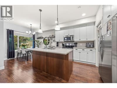 Open concept main floor kitchen-dining and living room with access to the back deck and BBQ