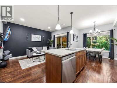 Open concept main floor kitchen-dining and living room with access to the back deck and BBQ