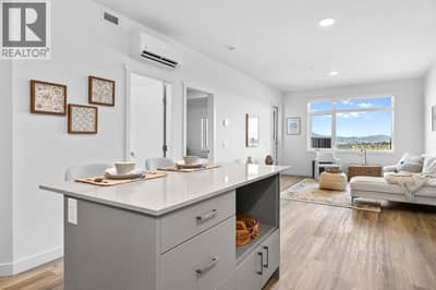 Kitchen and Living Room. Photos are of a similar home; some features may vary