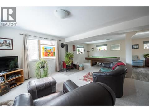Games room or suite with wood burning stove at 9292 Kokanee Road, Okanagan Landing, Vernon