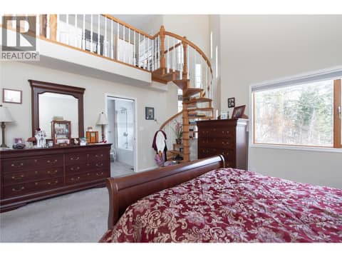Stairs leading to master bedroom studio at 9292 Kokanee Road, Okanagan Landing, Vernon