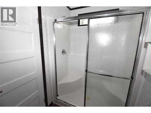 Sit down shower in the en-suite at 61 Antoine Road Unit# 24, Swan Lake West, Vernon