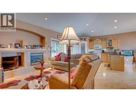 Family room with gas fireplace & door to backyard at 667 Mt York Drive, Middleton Mountain Coldstream