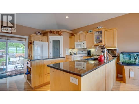 Island kitchen with Granite counters & Pantry at 667 Mt York Drive, Middleton Mountain Coldstream