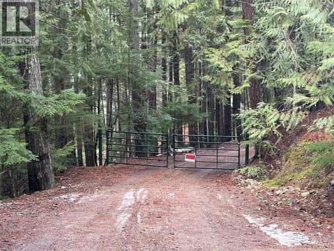 Access down into the property, secured gate at 8700 Mabel Lake Road, Mabel Lake South, Lumby